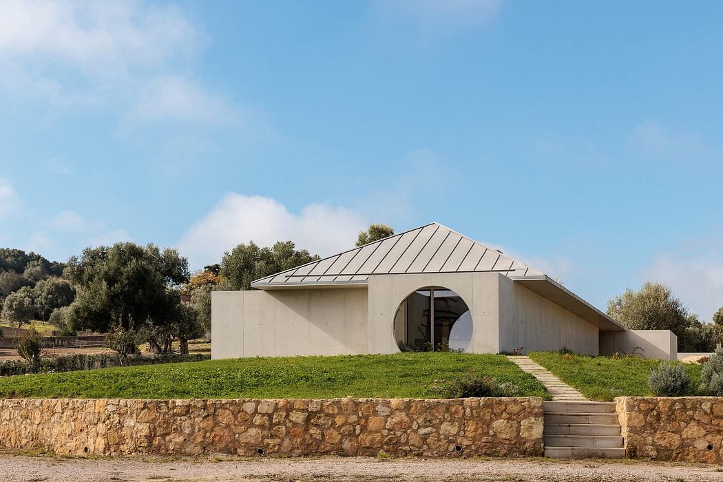 A modern architectural masterpiece with a striking roof design and stone walls.