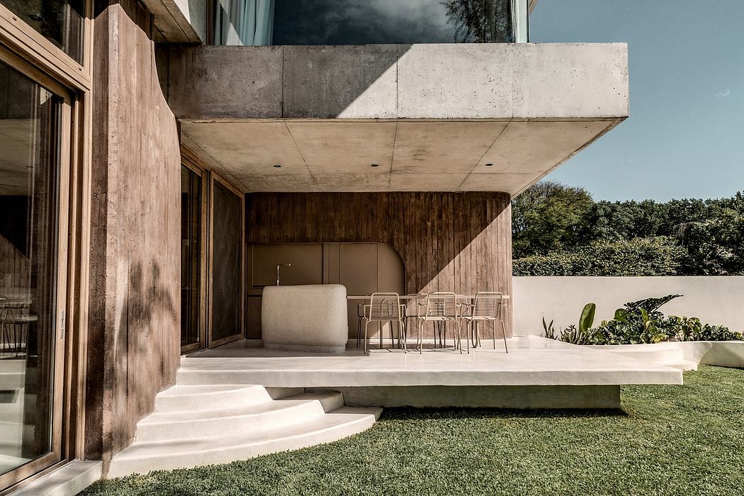 Modern concrete architecture with minimalist outdoor patio and seating.