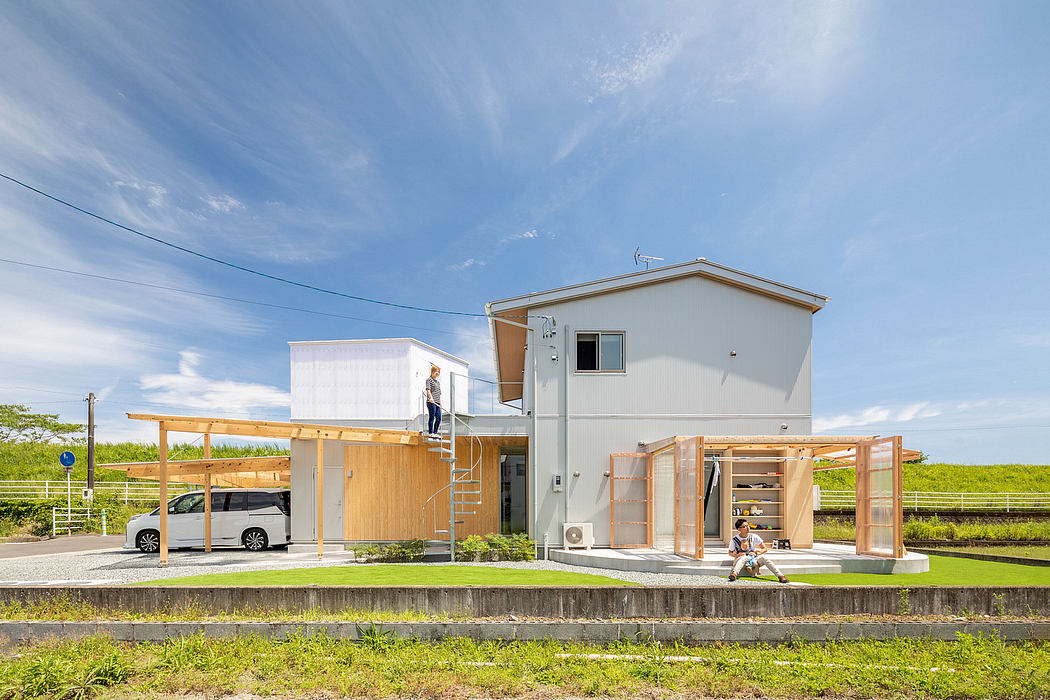 Modern two-story house with wooden porch, car port, and landscaping.