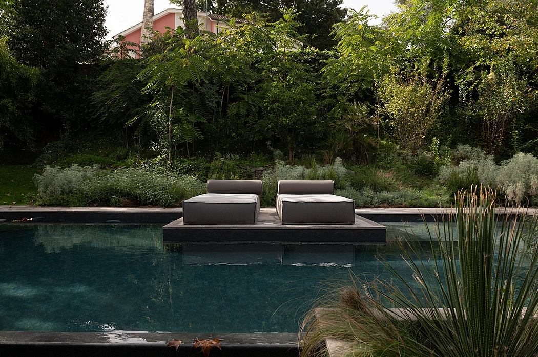 Serene backyard oasis with sleek floating lounges, lush greenery, and a tranquil pool.