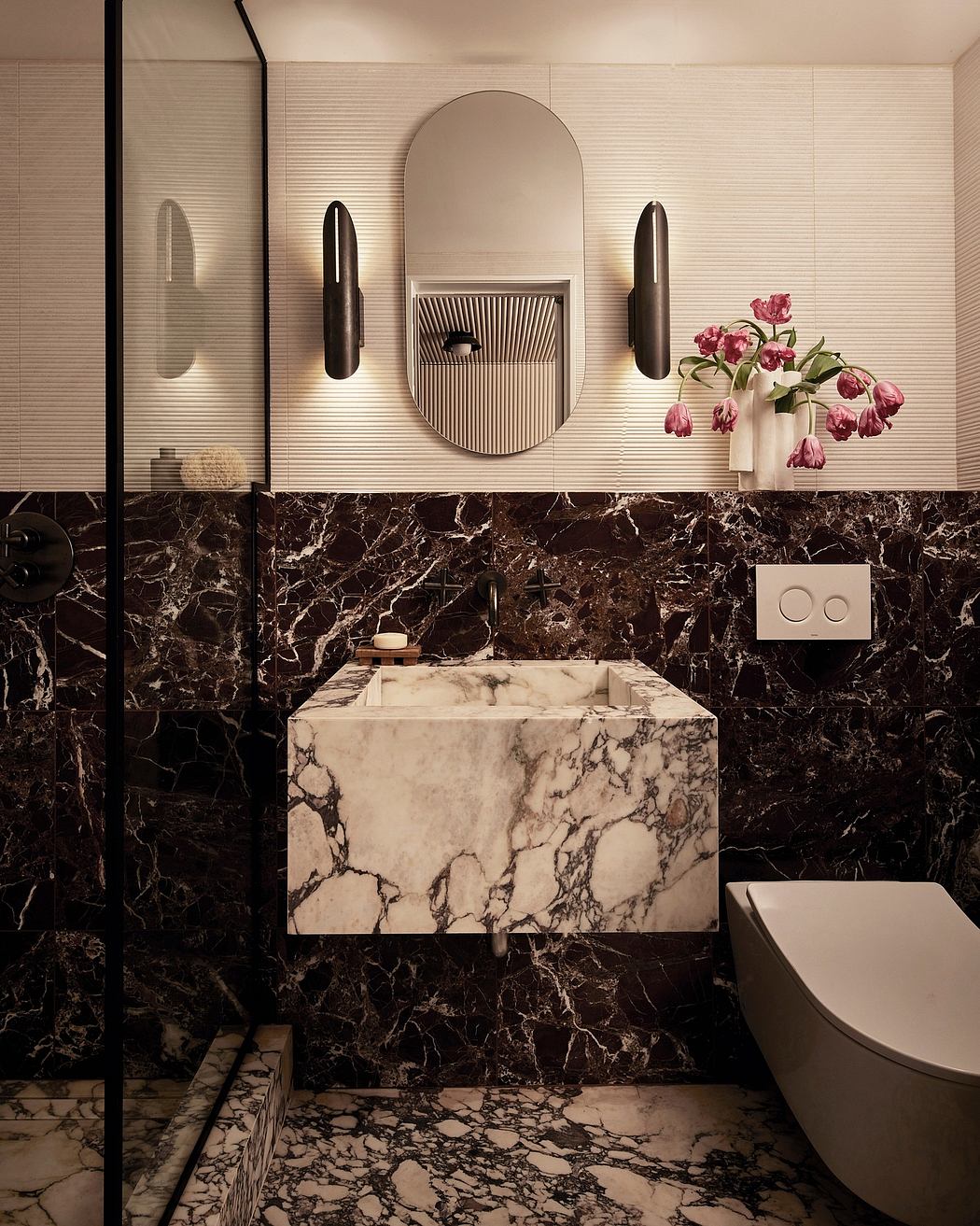 Sleek modern bathroom with dark marble vanity and architectural light fixtures.