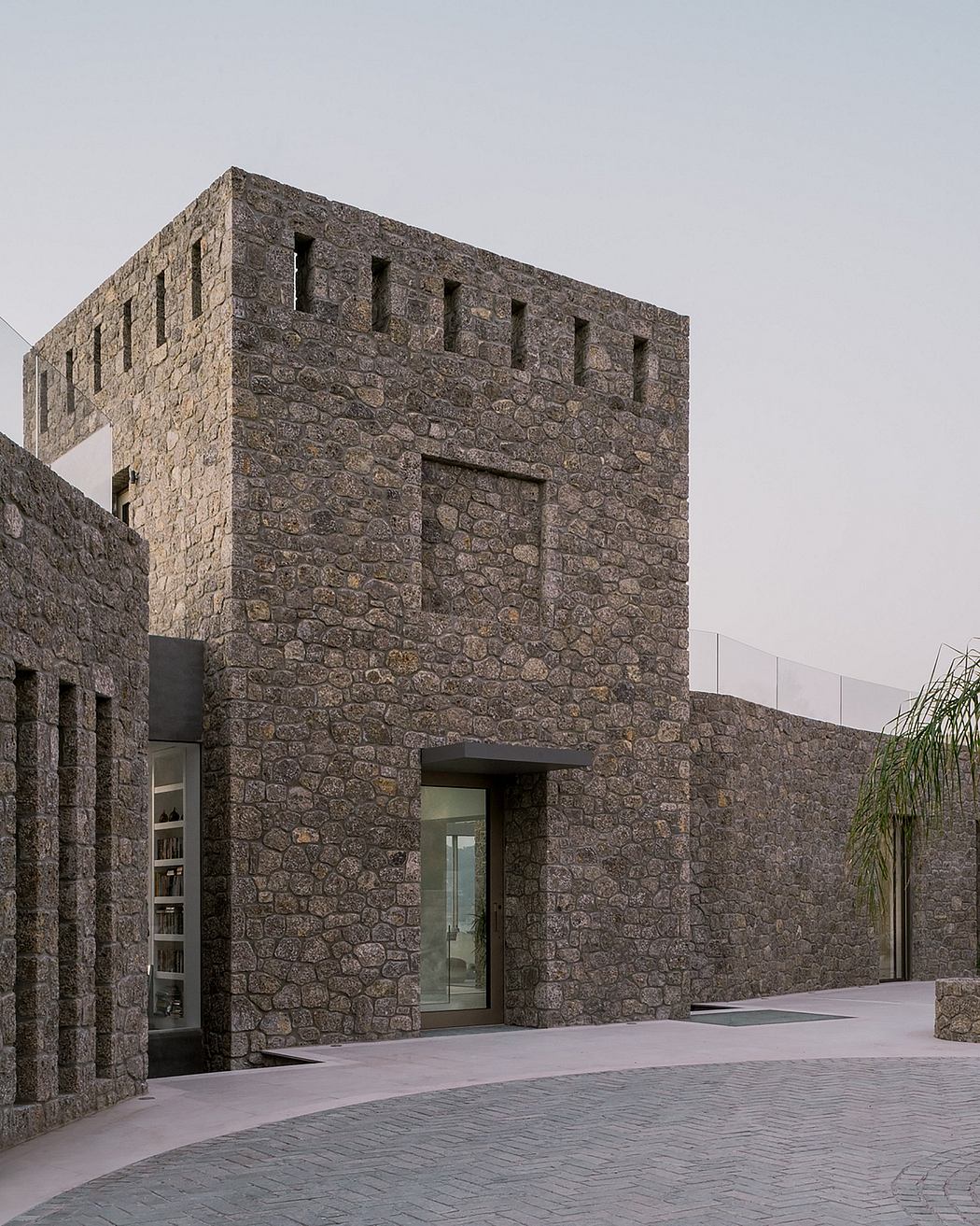 Massive stone building with geometric patterns, architectural details, and a modern entrance.