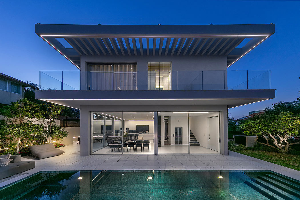 Sleek, modern home with clean lines, glass walls, and a lush backyard pool.