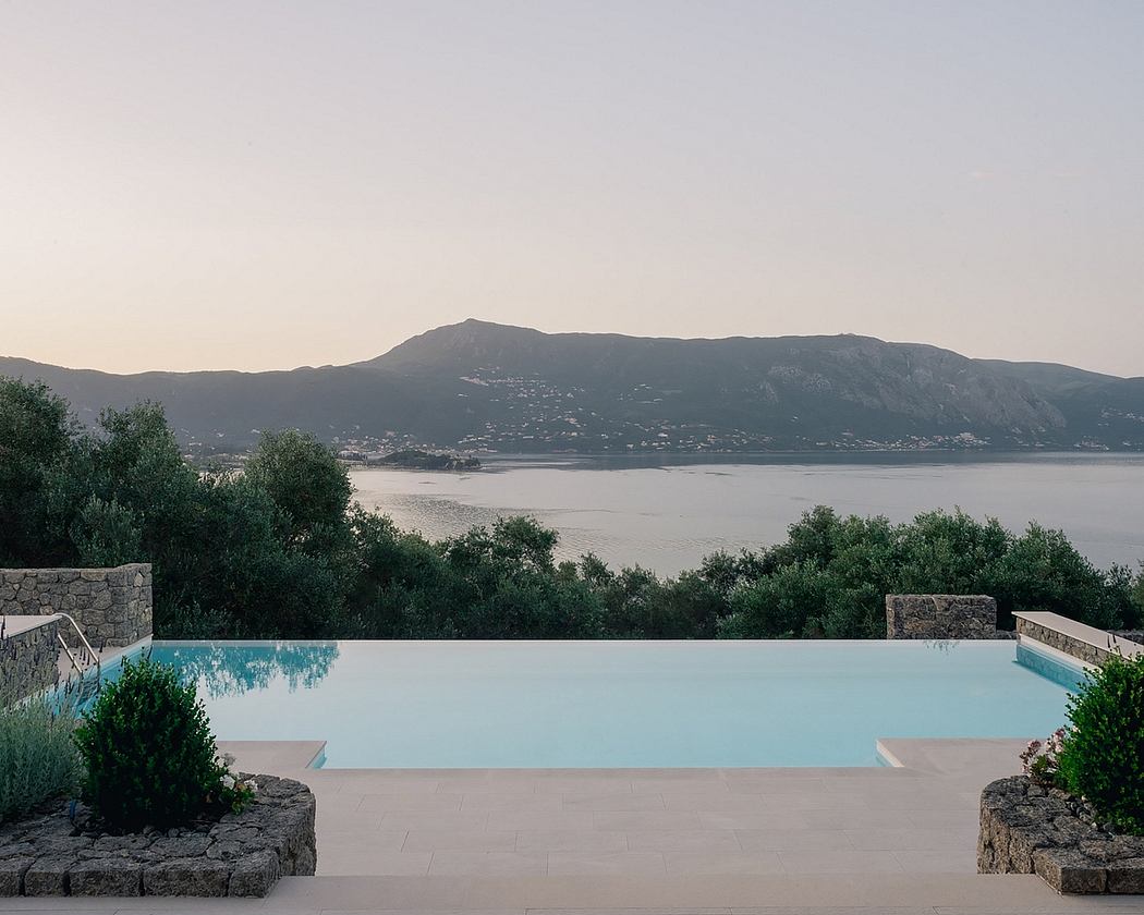 Stunning infinity pool with mountainous backdrop and lush greenery surrounding the area.