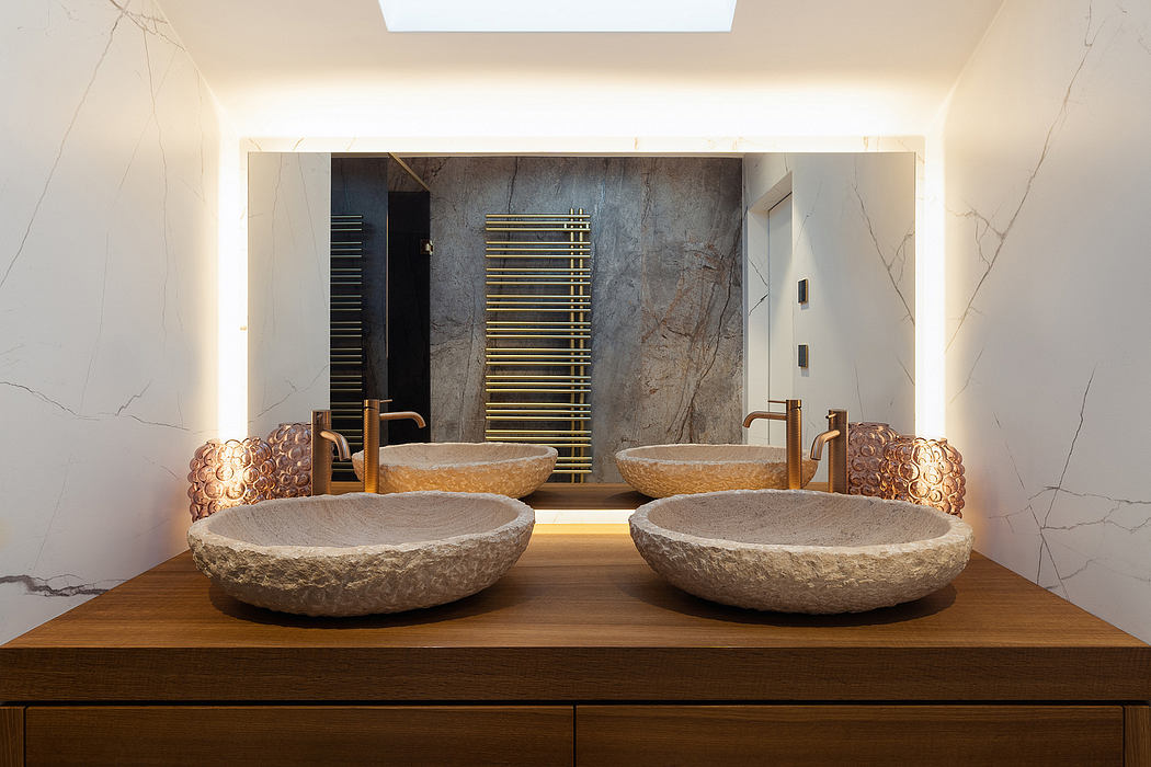 Elegant modern bathroom design featuring stone sinks on a wooden vanity, accented by tiled walls.