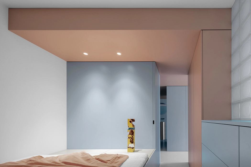 Minimalist interior with recessed lighting, geometric patterns, and textured surfaces.