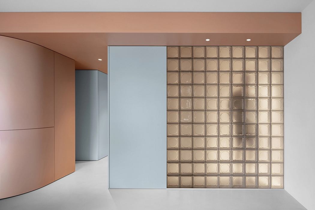 An architectural interior with clean lines, glass panels, and textured wall panels.