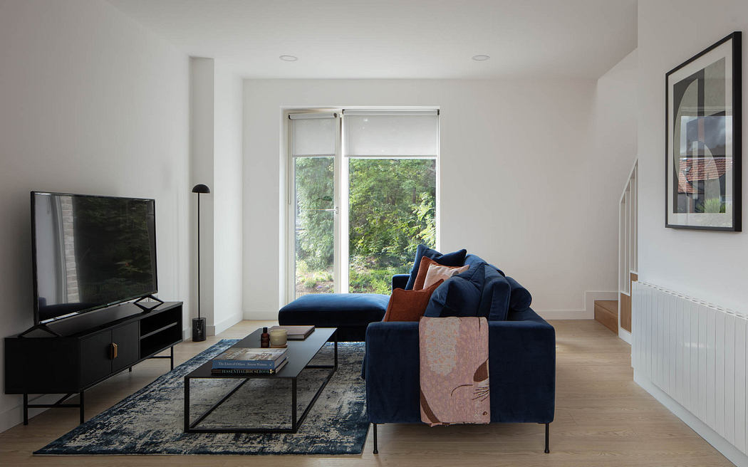 Stylish modern living room with large windows, navy blue sofa, and abstract artwork.