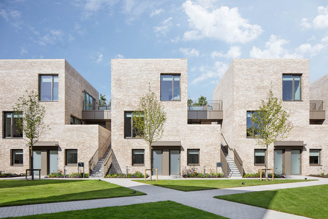 Architecturally-designed multi-unit apartment complex with uniform brick facade and landscaping.