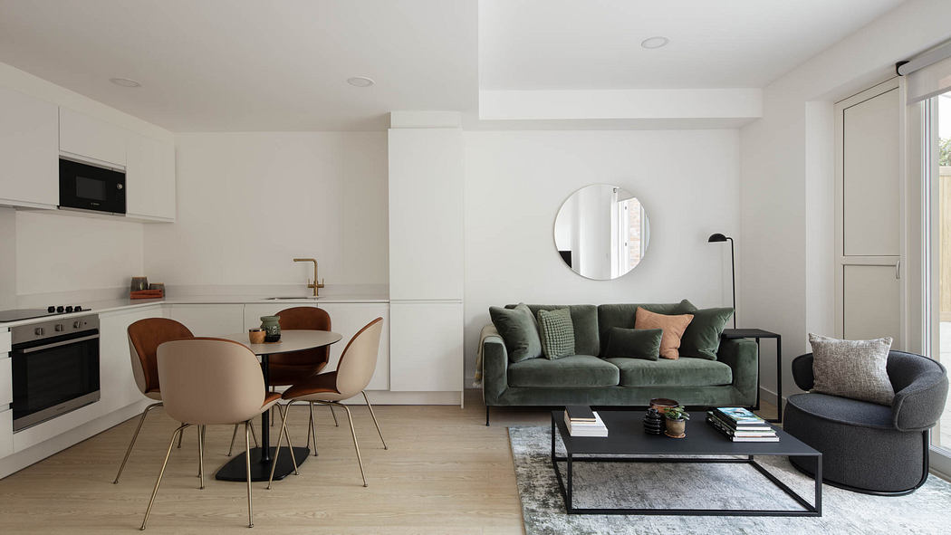 Minimalist open-plan living space with white walls, wood floors, and modern furniture.