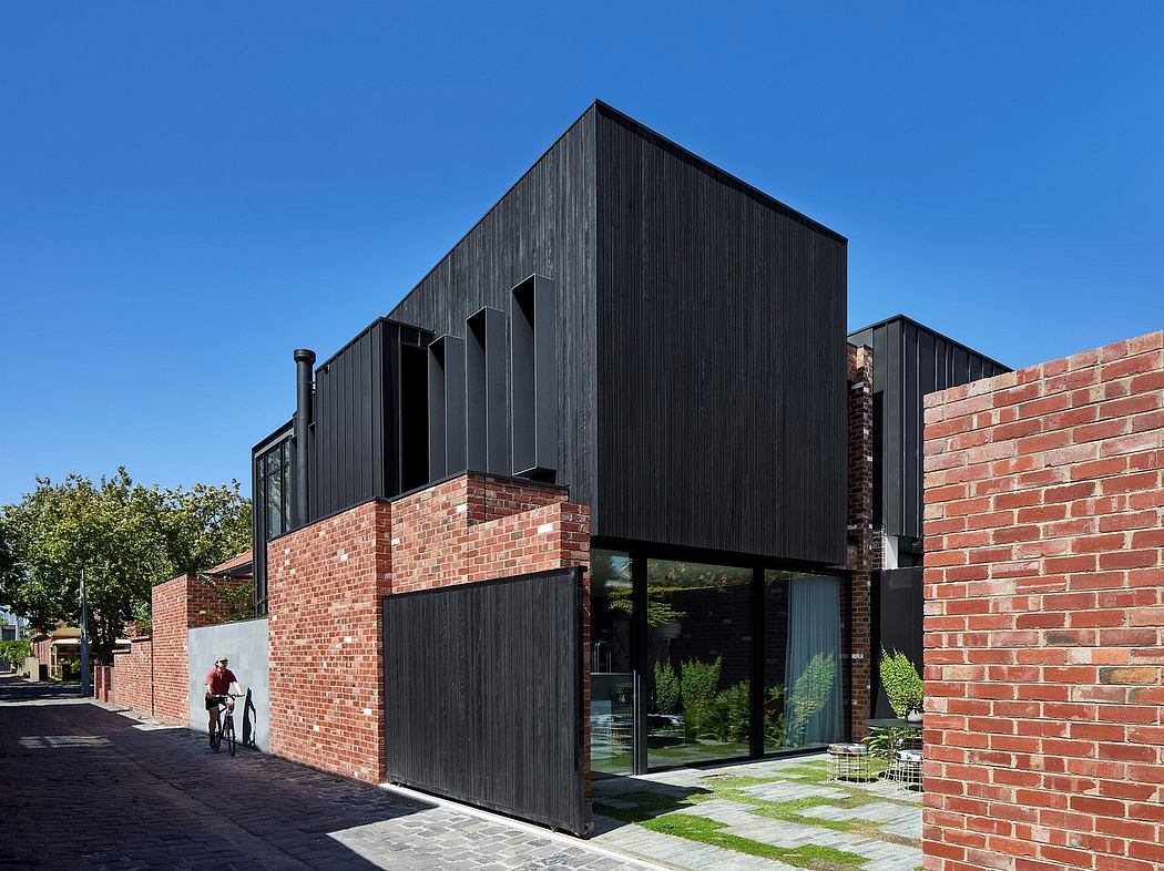 Modern brick and wood building with large windows and unique angular facade.