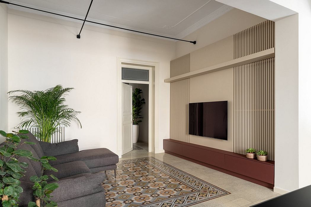 Minimalist living room with sleek built-in TV unit and lush plant accents.