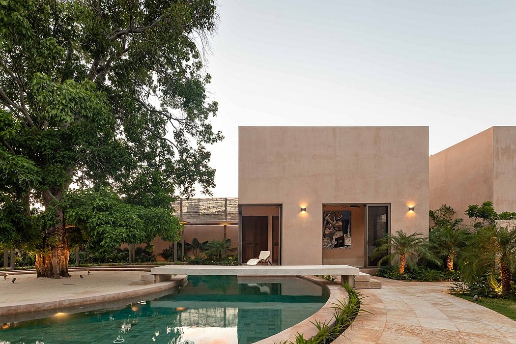 Modern, minimalist villa with expansive pool and lush greenery surrounding it.