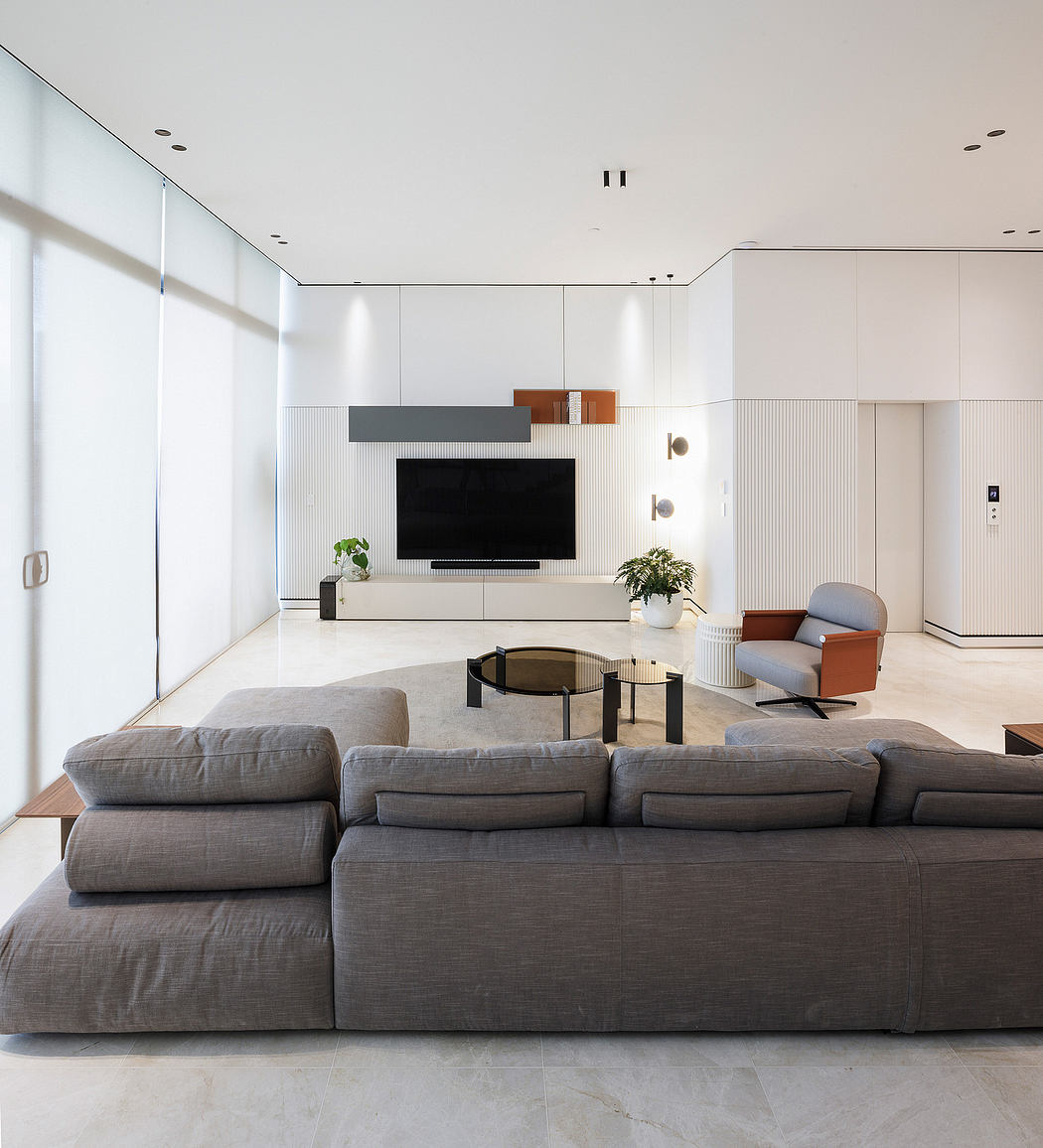 Spacious and modern living room with minimalist furniture, neutral colors, and clean lines.