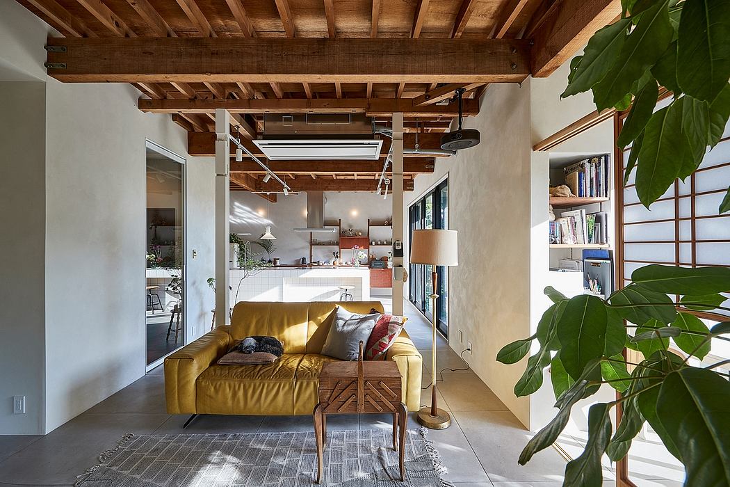 Warm, rustic living space with exposed wood beams, yellow sofa, and lush indoor plants.