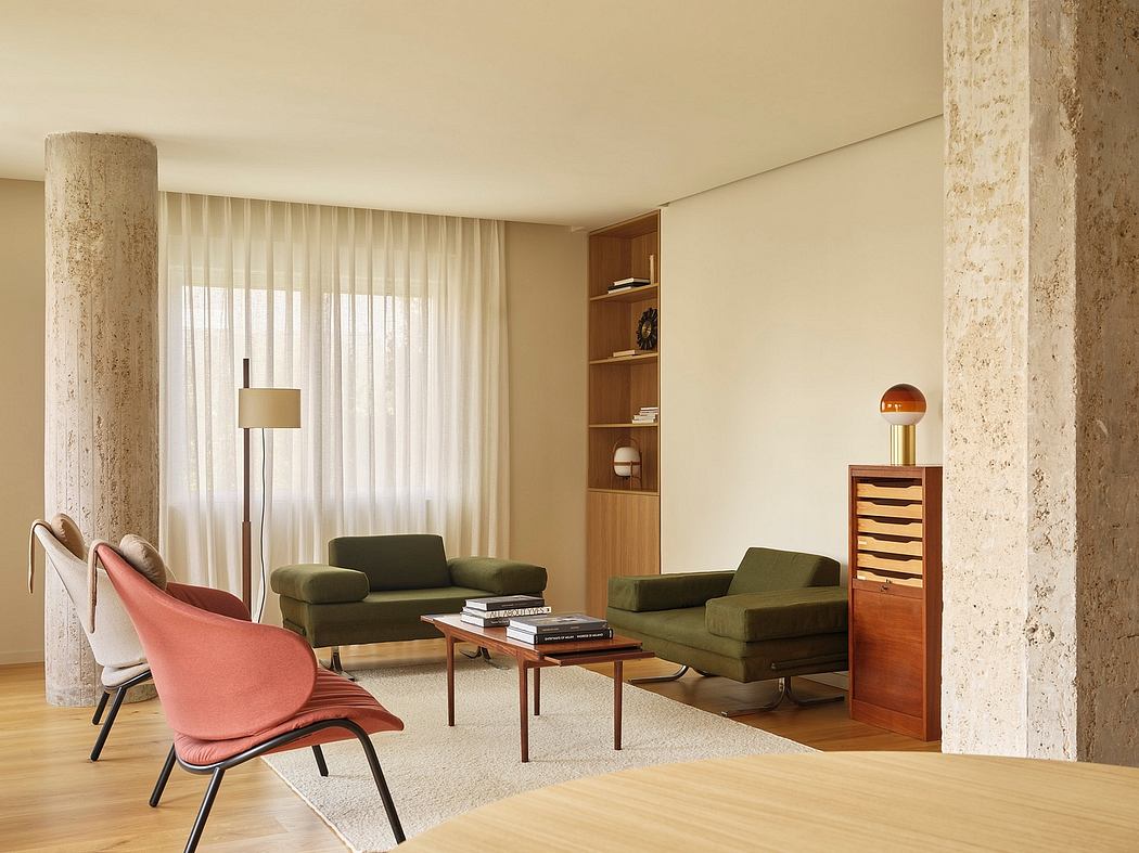 Midcentury modern living room with plush green sofas, wood shelving, and warm lighting.