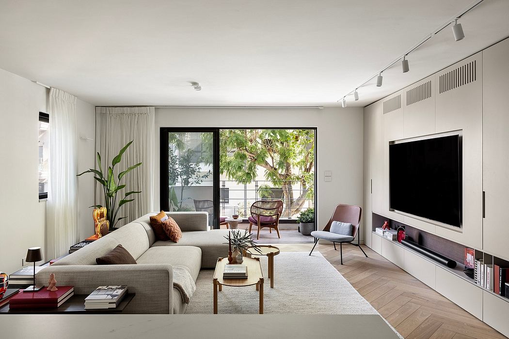 Modern, minimalist living room with large windows, stylish furniture, and lush greenery outside.