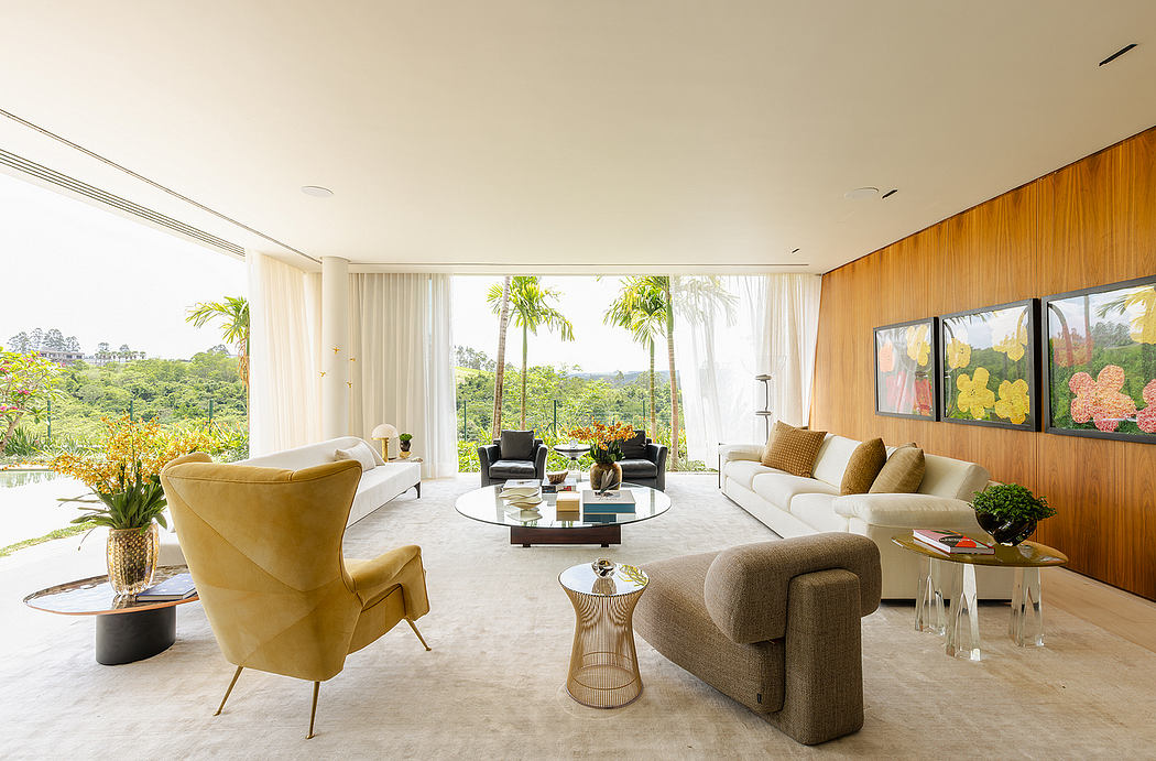 Elegant open-concept living room with wooden paneling, lush greenery, and stylish furnishings.