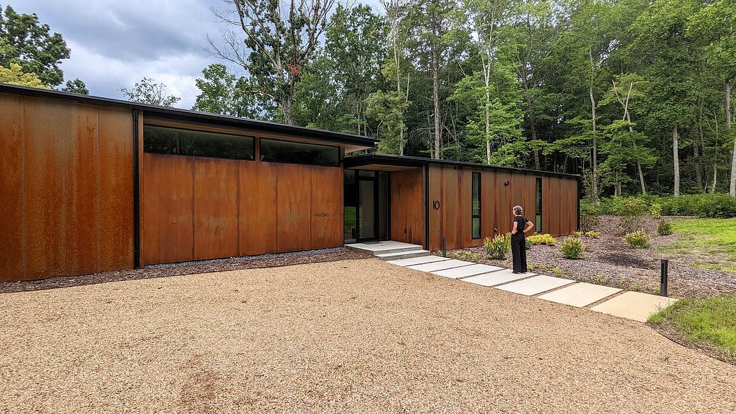 Striking midcentury modern home nestled in lush greenery, with clean lines and warm wood accents.