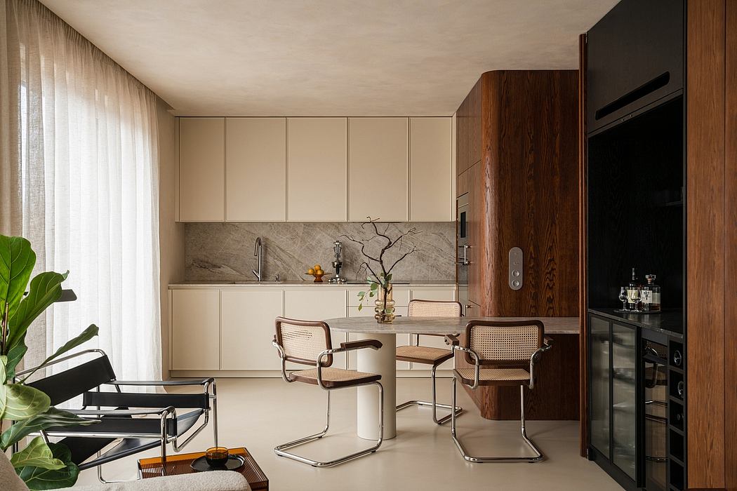 Minimalist kitchen with wood cabinetry, marble backsplash, and modernist dining chairs.