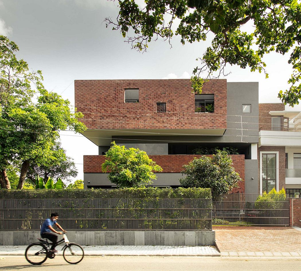 Striking modern brick building with unique balcony design and lush greenery.