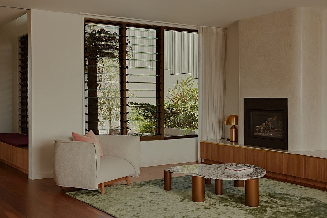 Warm, minimalist living space with large windows, natural materials, and textured rug.