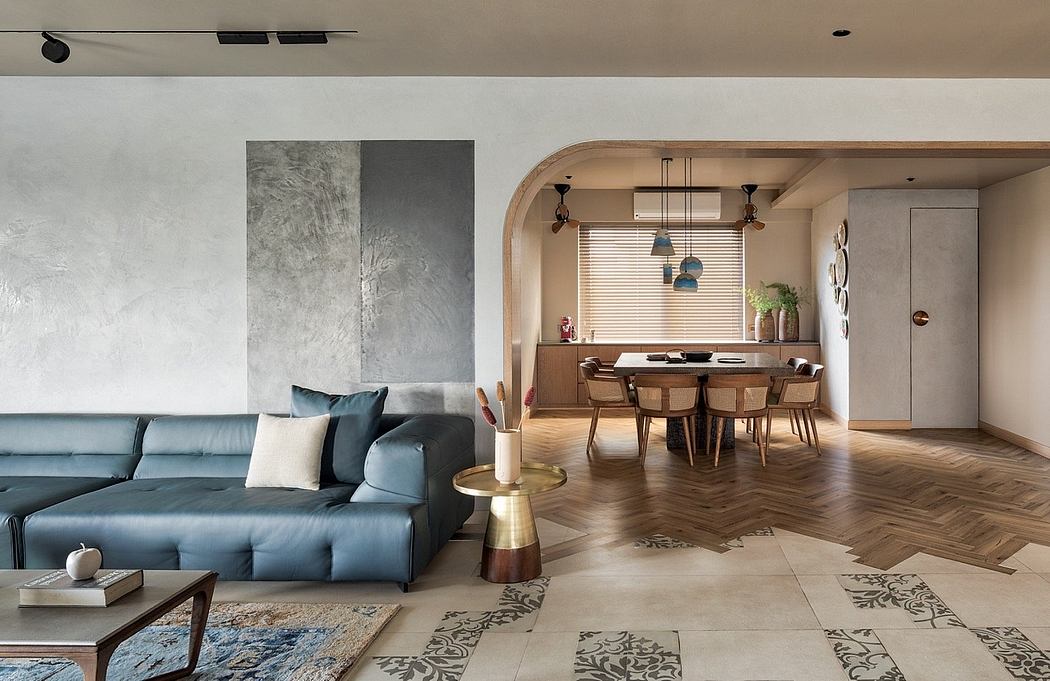 Spacious open-concept living room with modern furniture, arched doorway, and wood-paneled dining area.