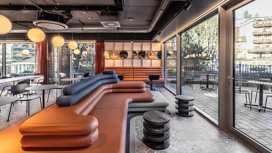 Sleek, contemporary interior with vibrant furnishings, pendant lighting, and expansive windows.