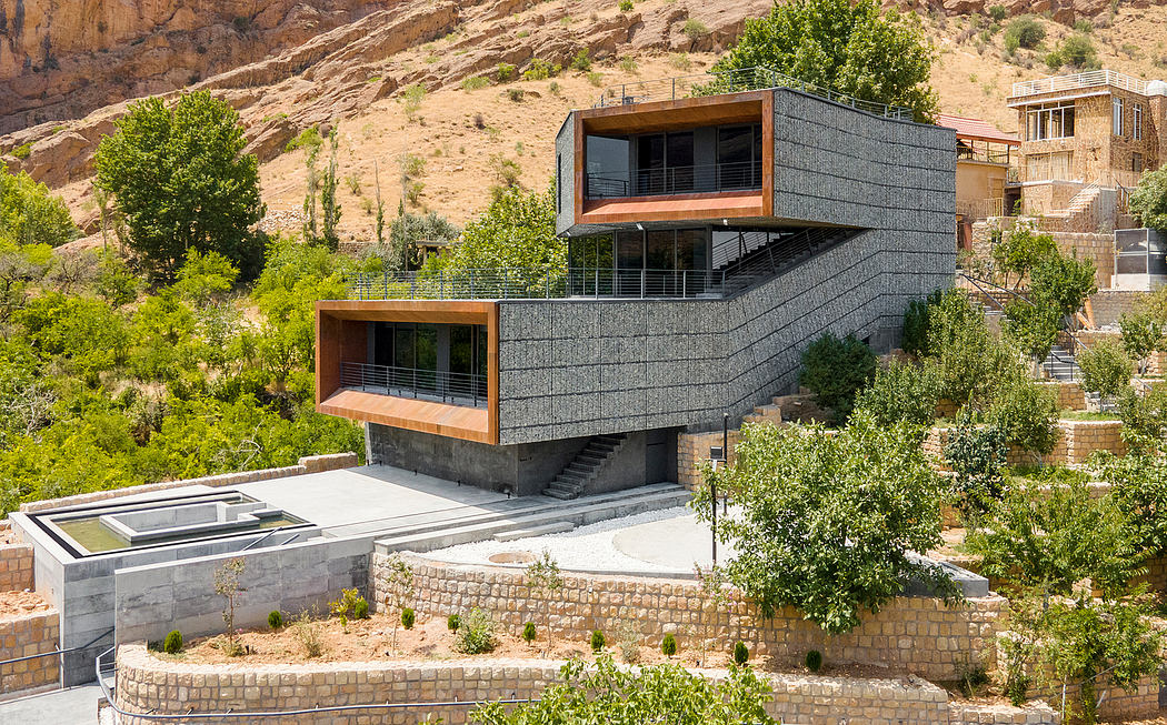 A modern, stepped architectural design nestled in lush greenery, featuring wooden accents.