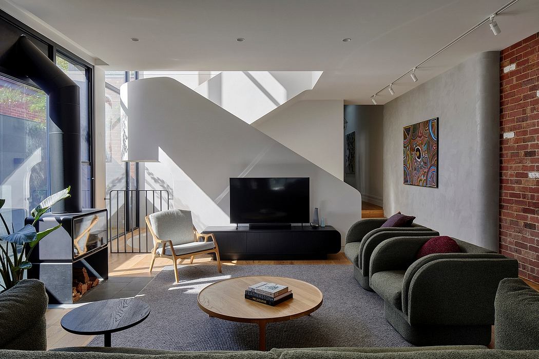 Modern living room with distinctive architectural features, including angled walls and skylights, complemented by a minimalist furniture arrangement.