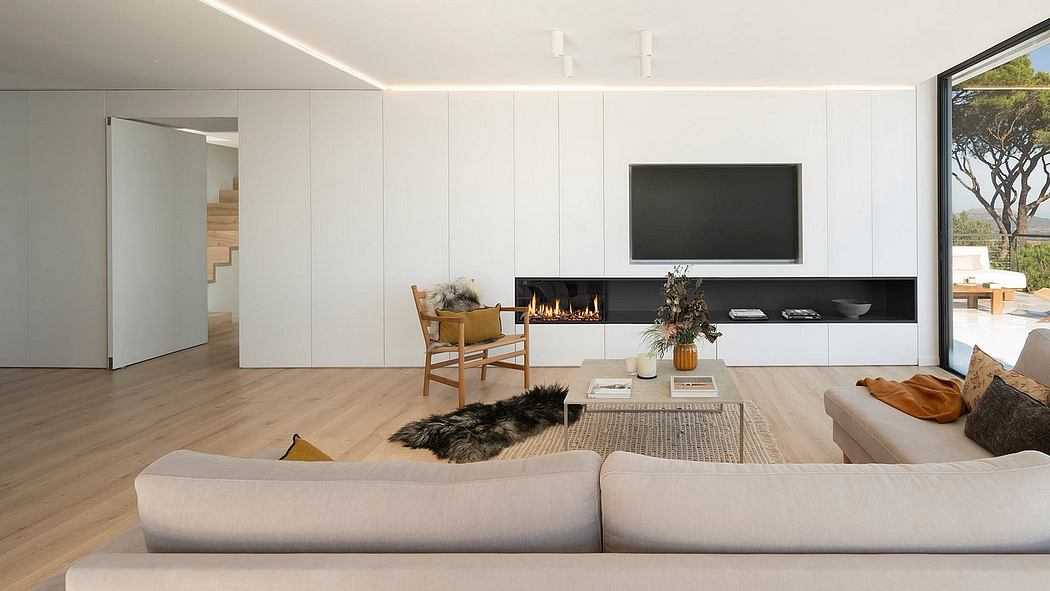 Modern, minimalist living room with sleek fireplace, wood floors, and built-in storage.