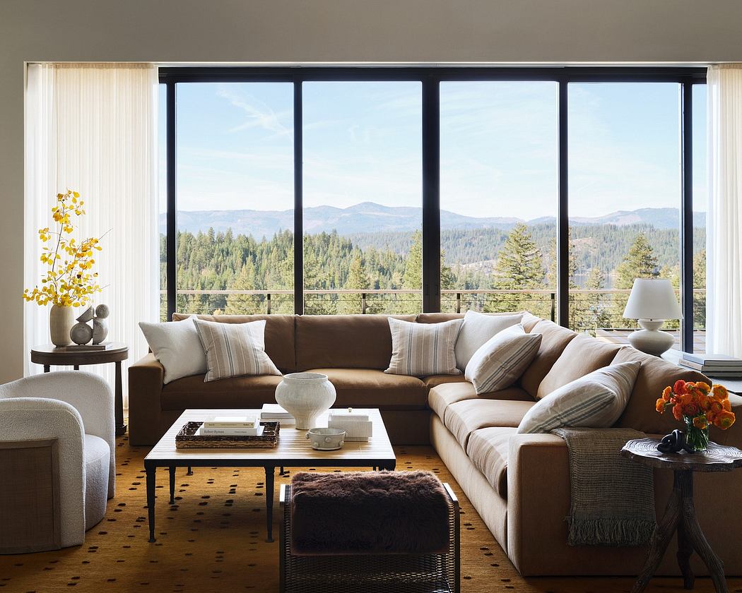 Spacious living room with large window offering scenic mountain and forest views.