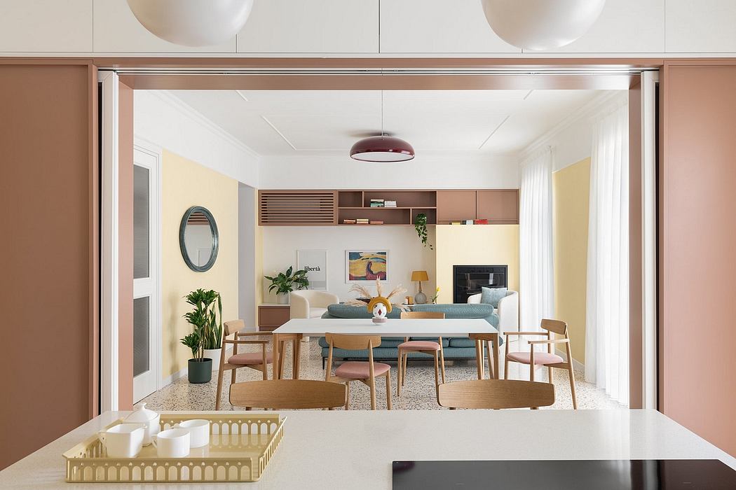 Open-concept living area with warm wood tones, minimalist furniture, and recessed lighting.