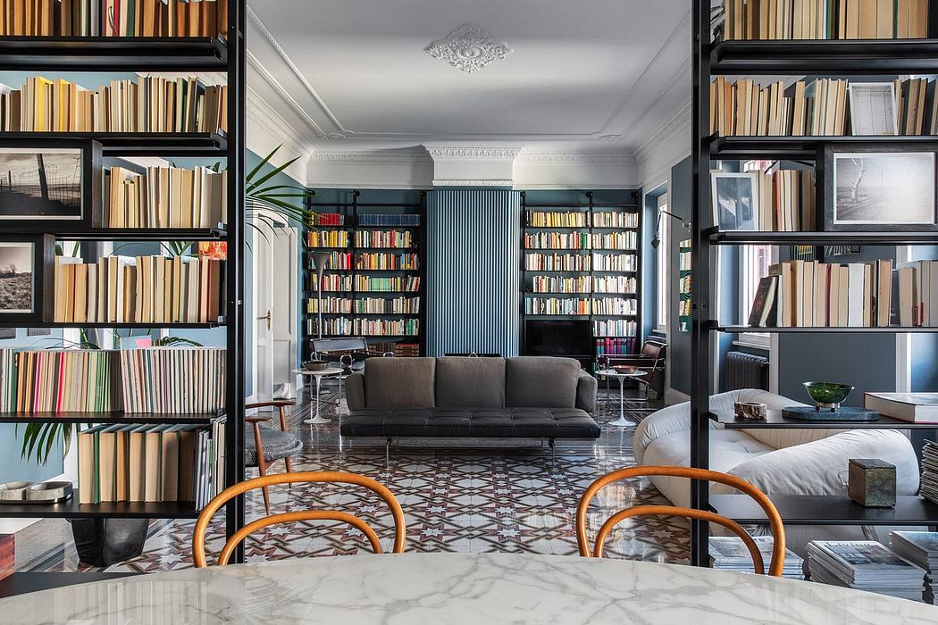 Elegant library-like space with bookshelves, sofa, and patterned tile floor.