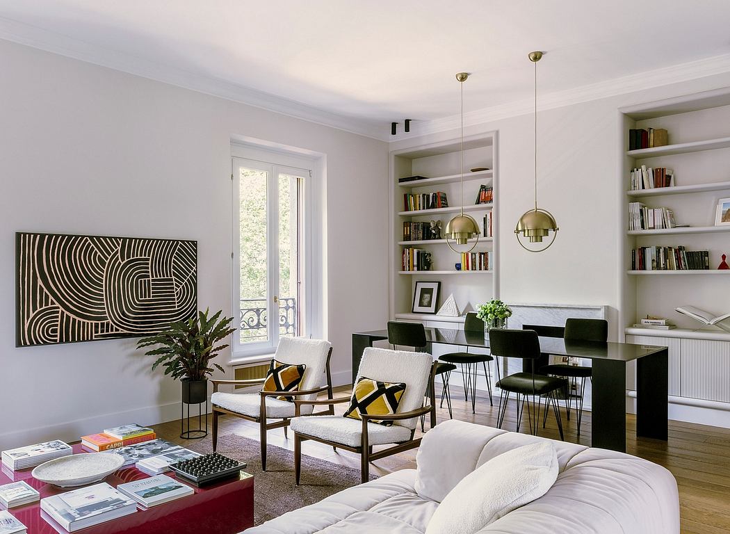 Chic modern living room with geometric artwork, built-in shelving, and brass pendant lamps.