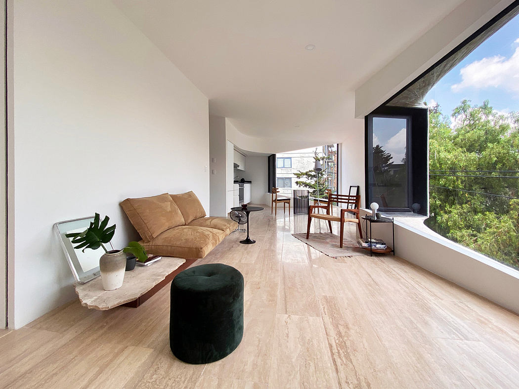 Spacious, modern living room with hardwood floors, large window, and minimalist decor.