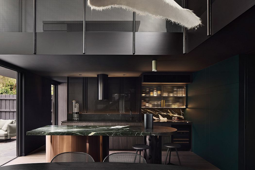 Dramatic modern kitchen with dark wood, green marble island, and industrial lighting.