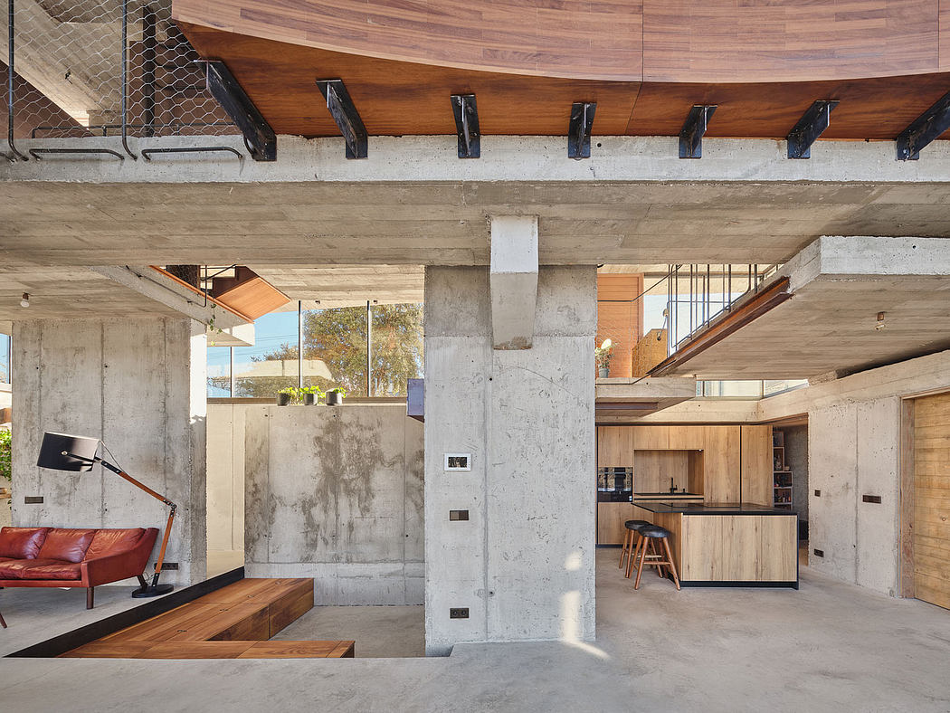 An open-concept interior with concrete walls, wood accents, and a cozy living space.