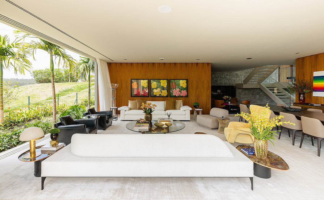 Spacious open-concept interior with wood paneling, large windows, and modern furnishings.