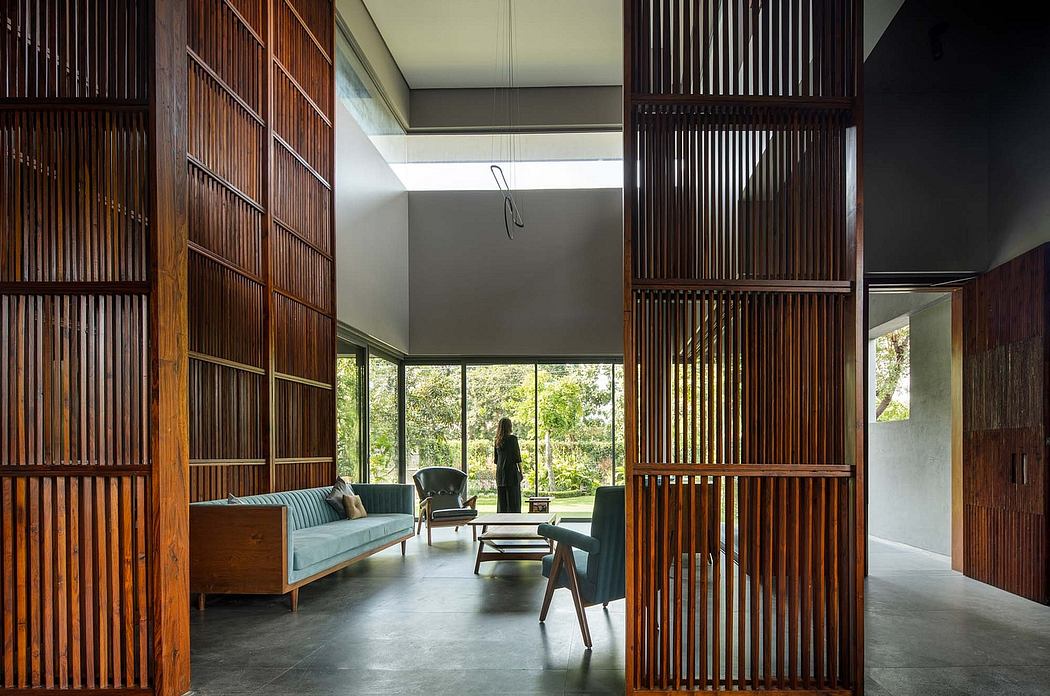 Minimalist living room with wooden slat partitions, modern furniture, and views of greenery.