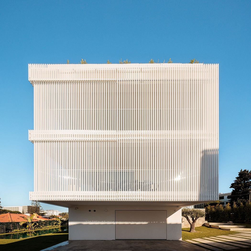 A striking modernist building with a sleek, geometric facade and a covered outdoor area.