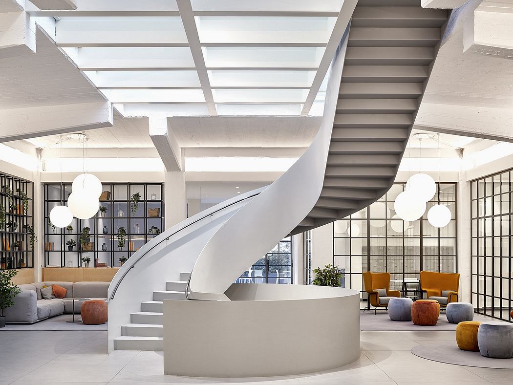 Modern, open-concept interior with spiral staircase, bookshelves, and cozy seating areas.