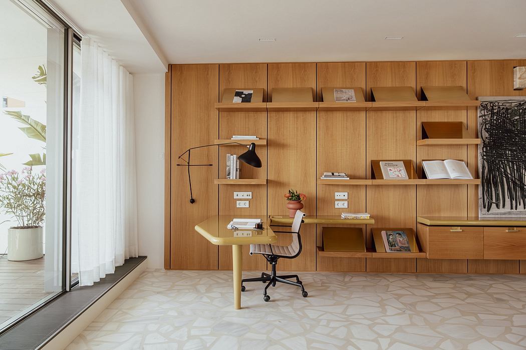 Minimalist home office with a wooden wall unit, adjustable chair, and decorative elements.