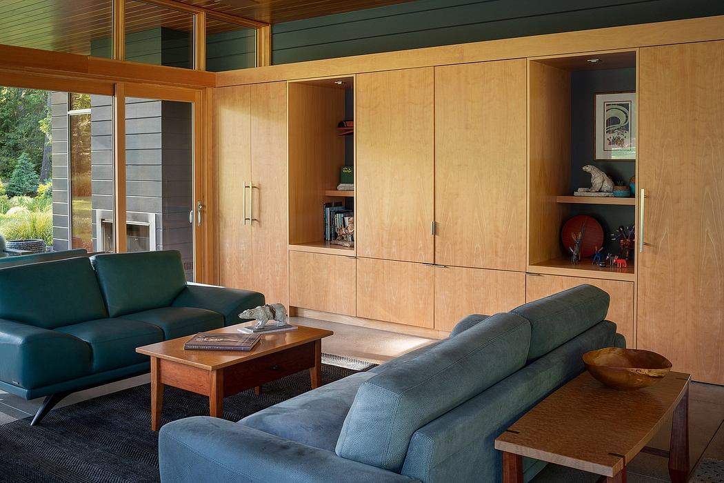A cozy living room with wooden wall paneling, built-in cabinetry, and comfortable seating.