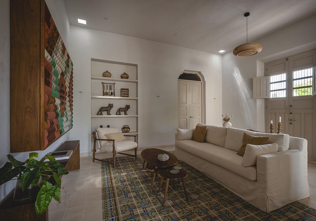 Spacious living room with patterned tile floor, built-in shelves, and plush beige sofa.