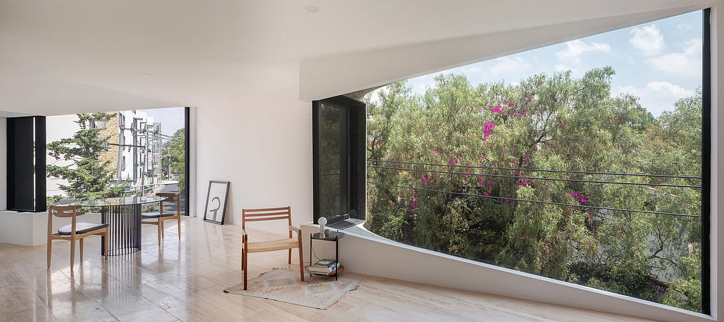 Expansive, airy interior with large windows offering panoramic views of the lush greenery outside.