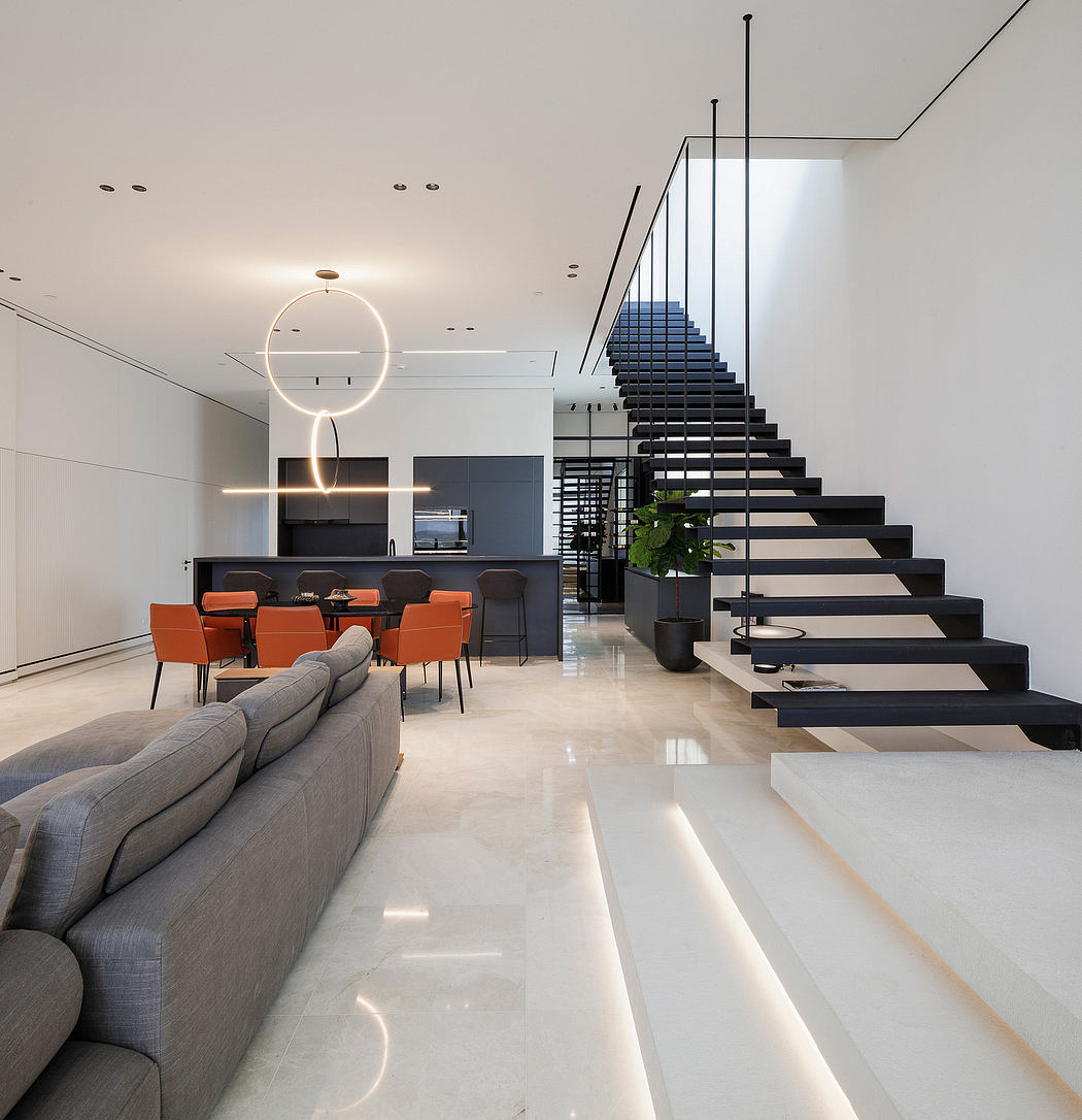 Sleek modern interior with minimalist staircase, open-plan living area, and stylish furniture.