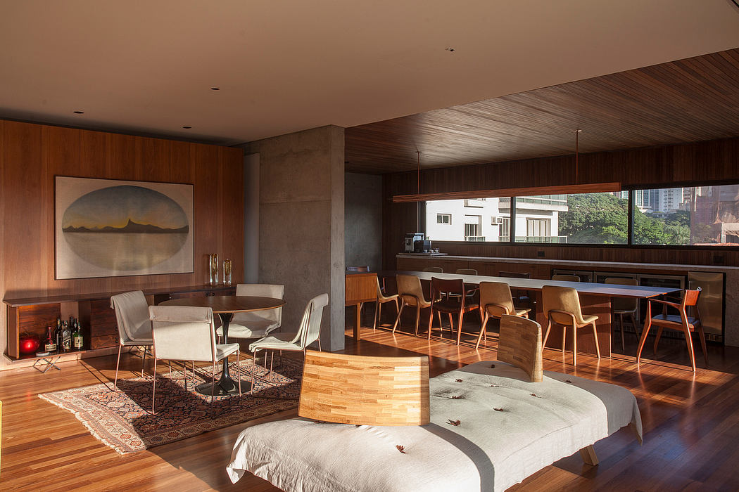 Modernist living room with sleek wooden furnishings, vibrant rug, and scenic artwork.