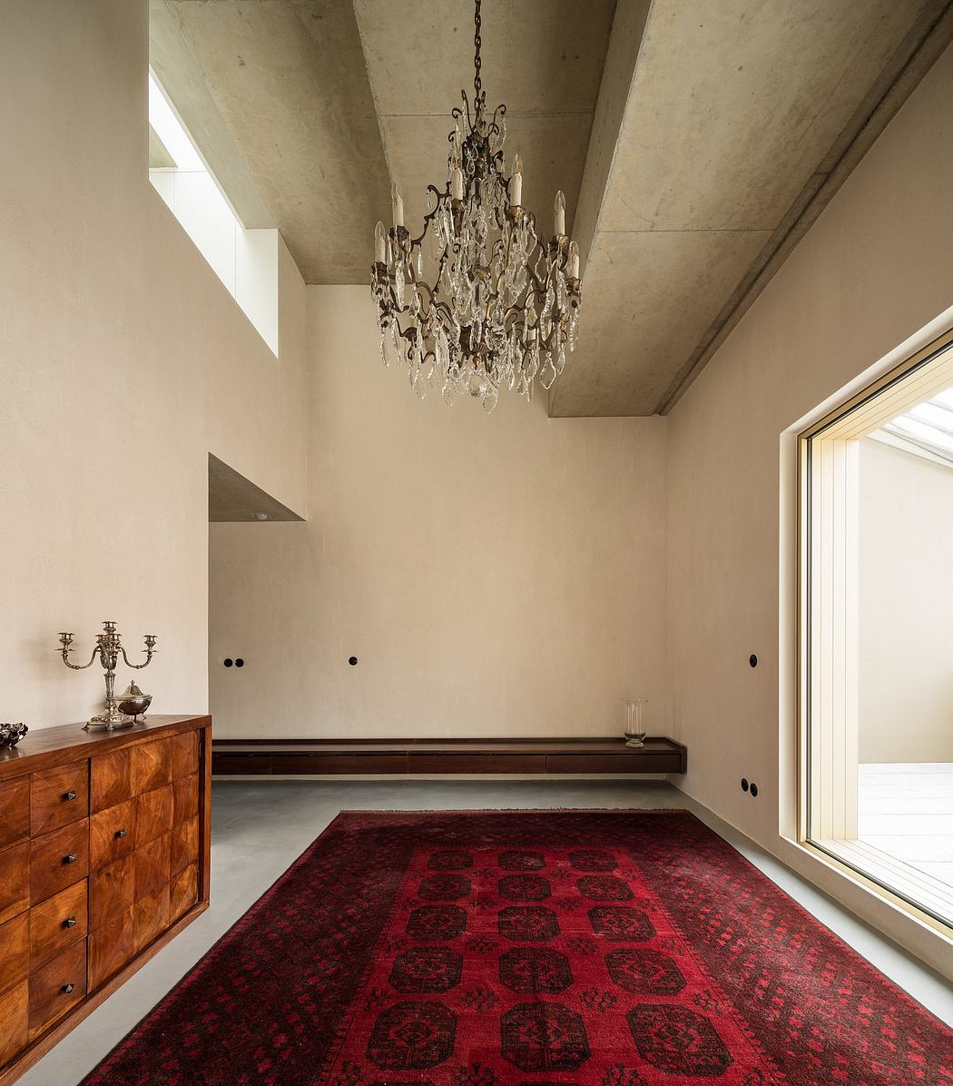 Elegant chandelier and wooden furniture in a minimalist concrete interior.