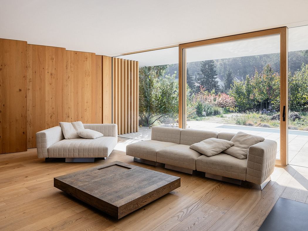 Elegant modern interior with expansive wooden walls, minimalist furniture, and panoramic view.